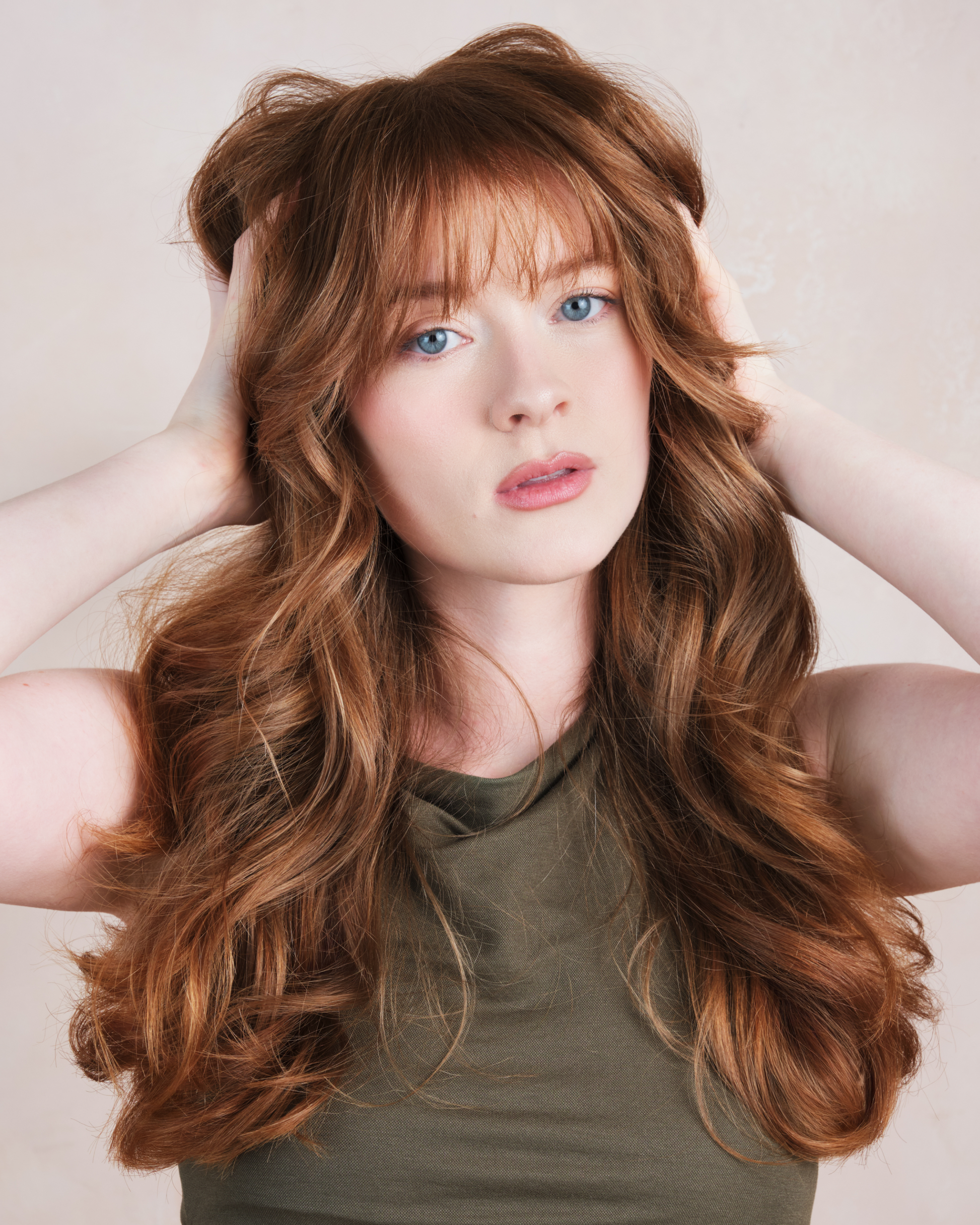 Woman with long wavy brown hair against a plain background|variant:93-oz,16-oz,18-oz