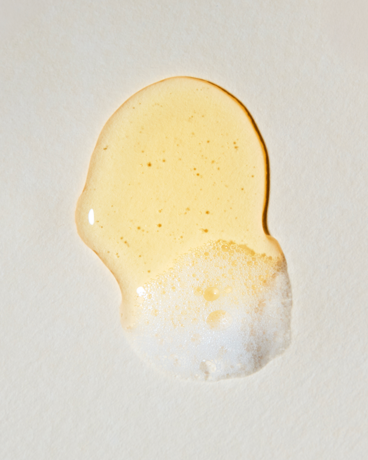 Close-up of a droplet of honey on a light background|variant:93-oz,18-oz