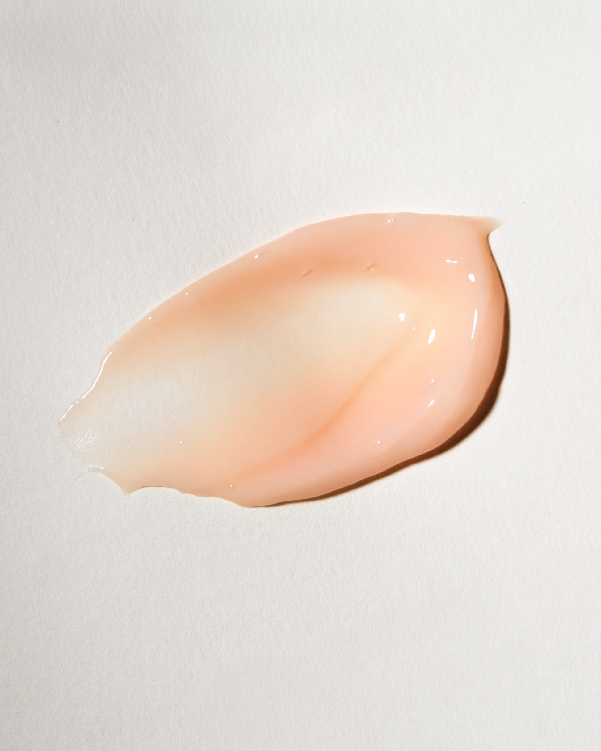 Pink cosmetic cream swatch on a light gray background|variant:93-oz,16-oz