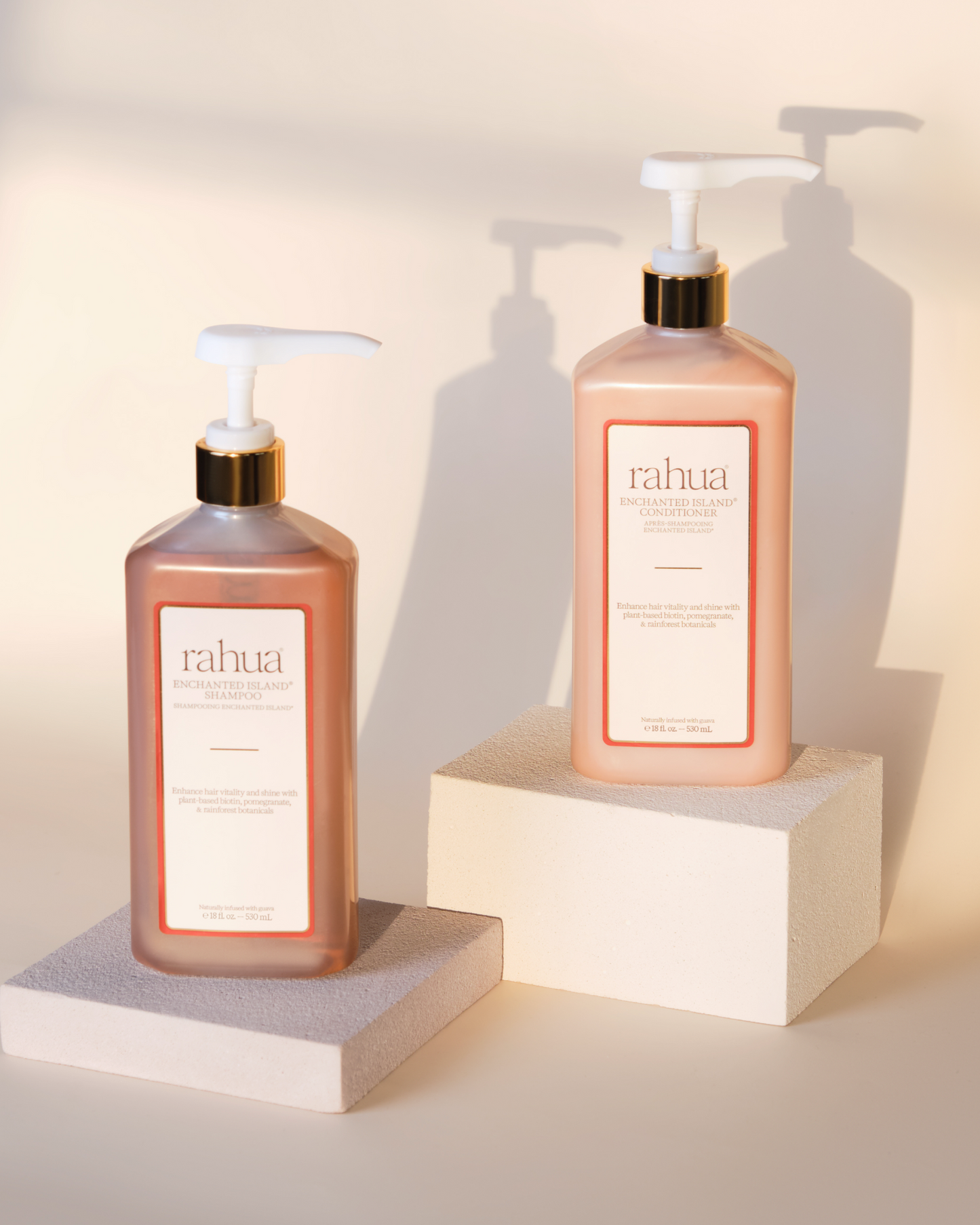 Two bottles of Rahua hair care products on a neutral background|variant:16-oz