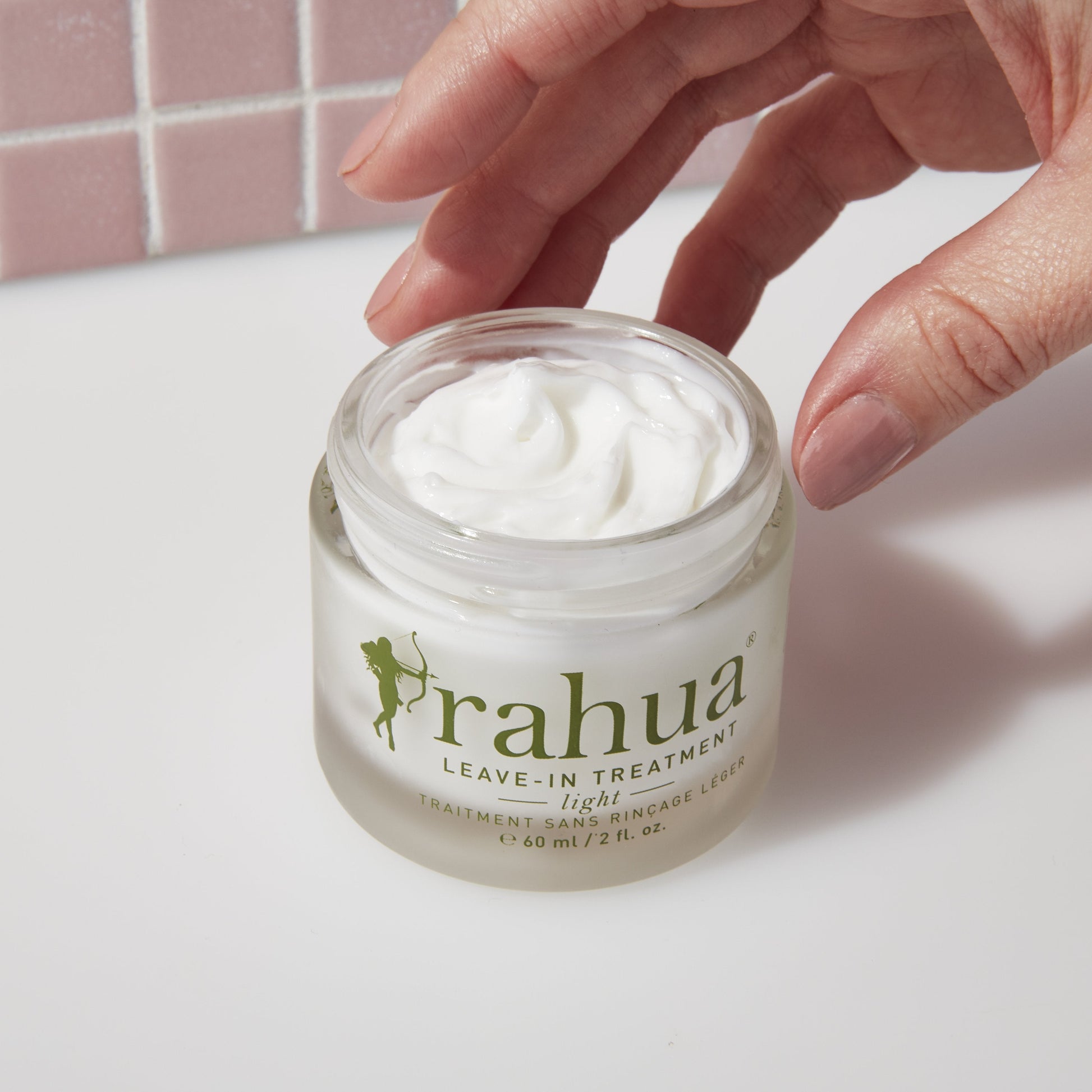 leave in treatment light with its creamy texture spread in the background
