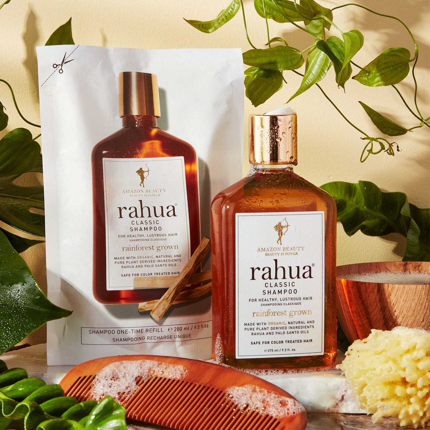 rahua classic shampoo refill and bottle with a bowl full of shampoo foam and foam spread over comb and floor