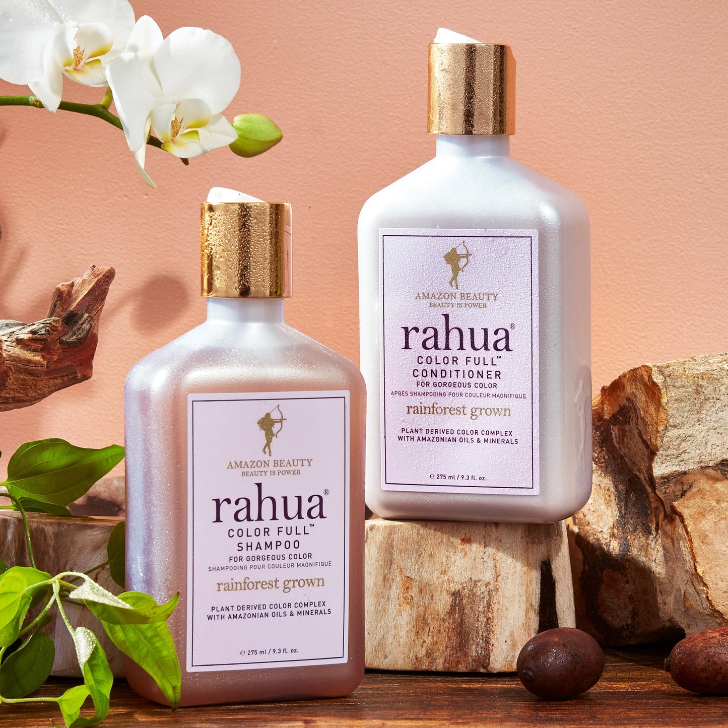 Rahua color full shampoo and conditioner with rahua seeds, gardenia flower placed on wooden block