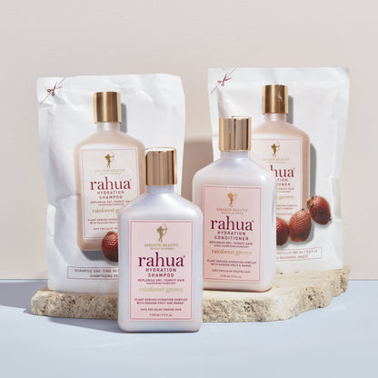 Rahua Hydration Shampoo and conditioner refills and bottles kept on a marble plank