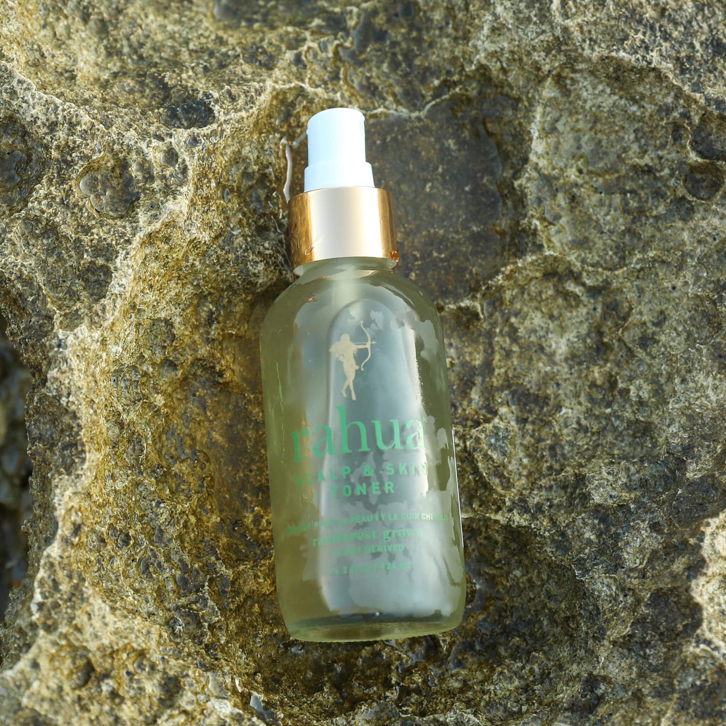 Rahua Scalp and Skin Toner on beautiful green stone with water